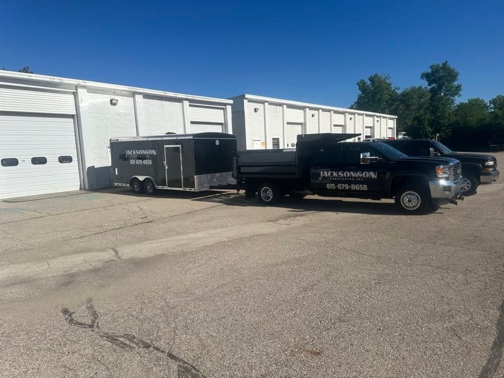 Jackson Mason truck and trailer parked outside a warehouse with clear signage and logo.